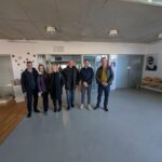 A group of people stand in a corridor at the Lubiana University Faculty of Eletrical Engineering