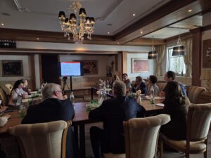 People sat in a room looking at a screen